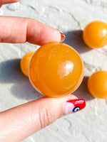 Load image into Gallery viewer, Small orange calcite sphere - Intuitively selected
