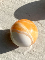 Load image into Gallery viewer, Large Orange Calcite sphere
